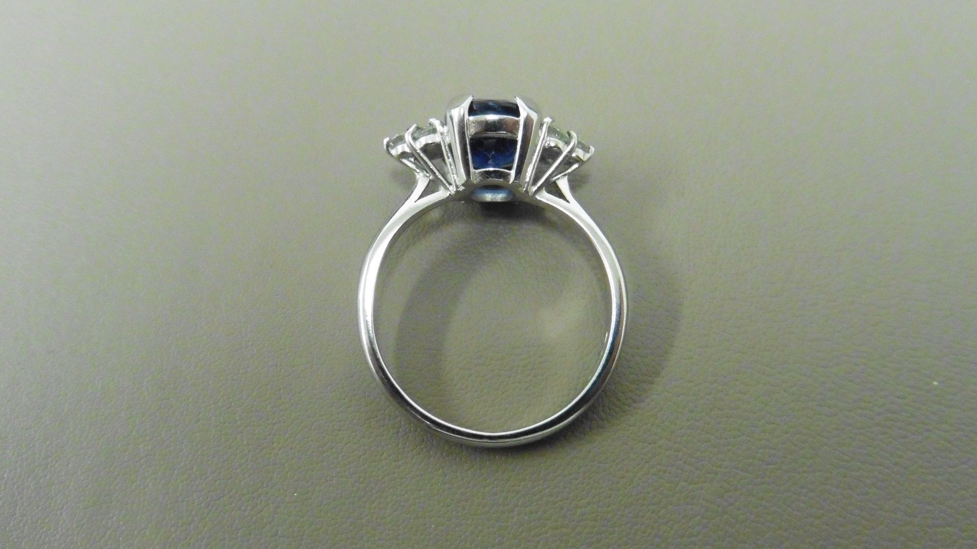 2.50ct sapphire and diamond dress ring. 9x7 oval cut ( glass filled ) with 3 small brilliant cut - Image 2 of 3