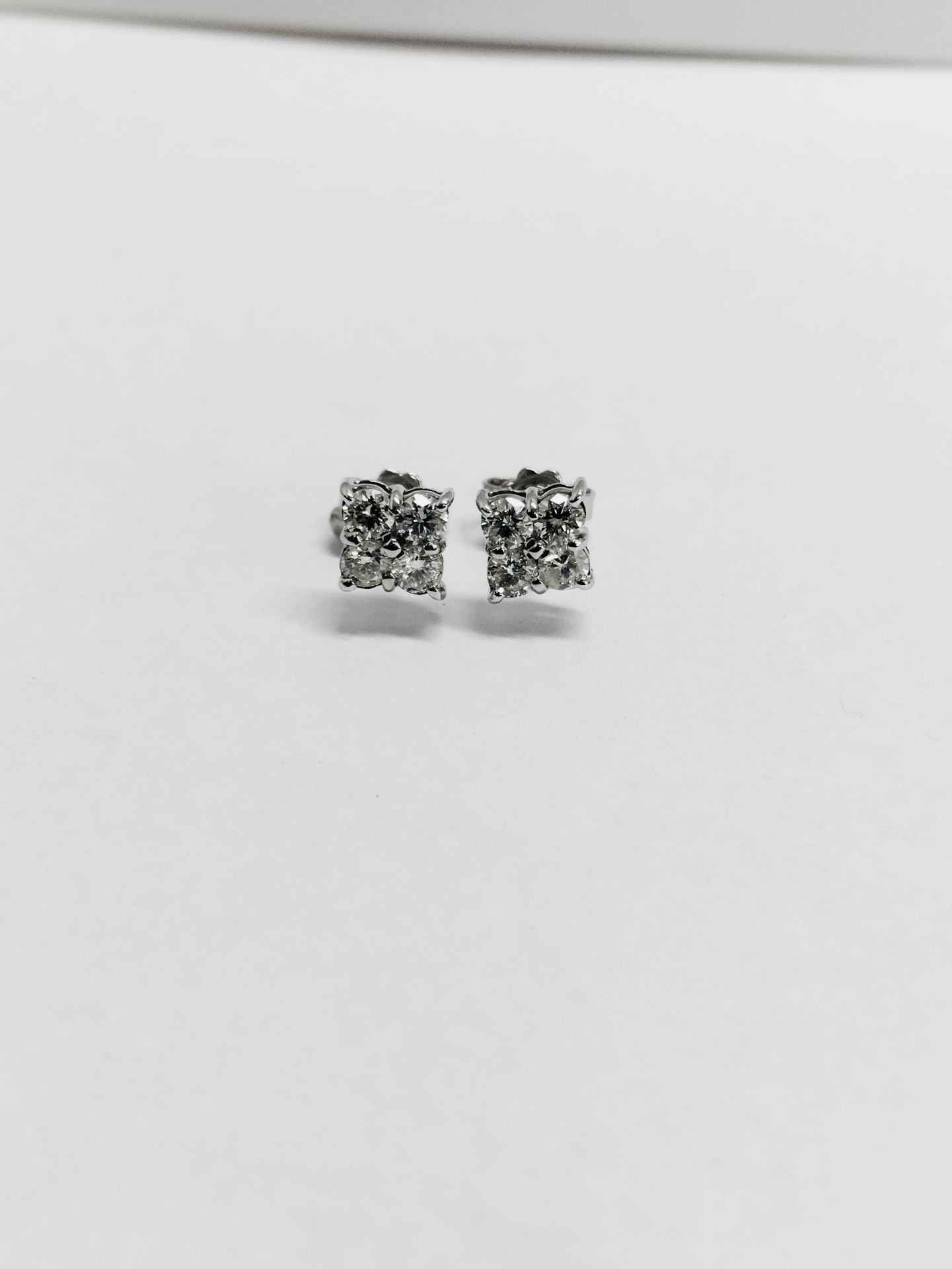 0.80ct dimond cluster style stud earrings. Each set with 4 small brillint cut diamonds, I colour and