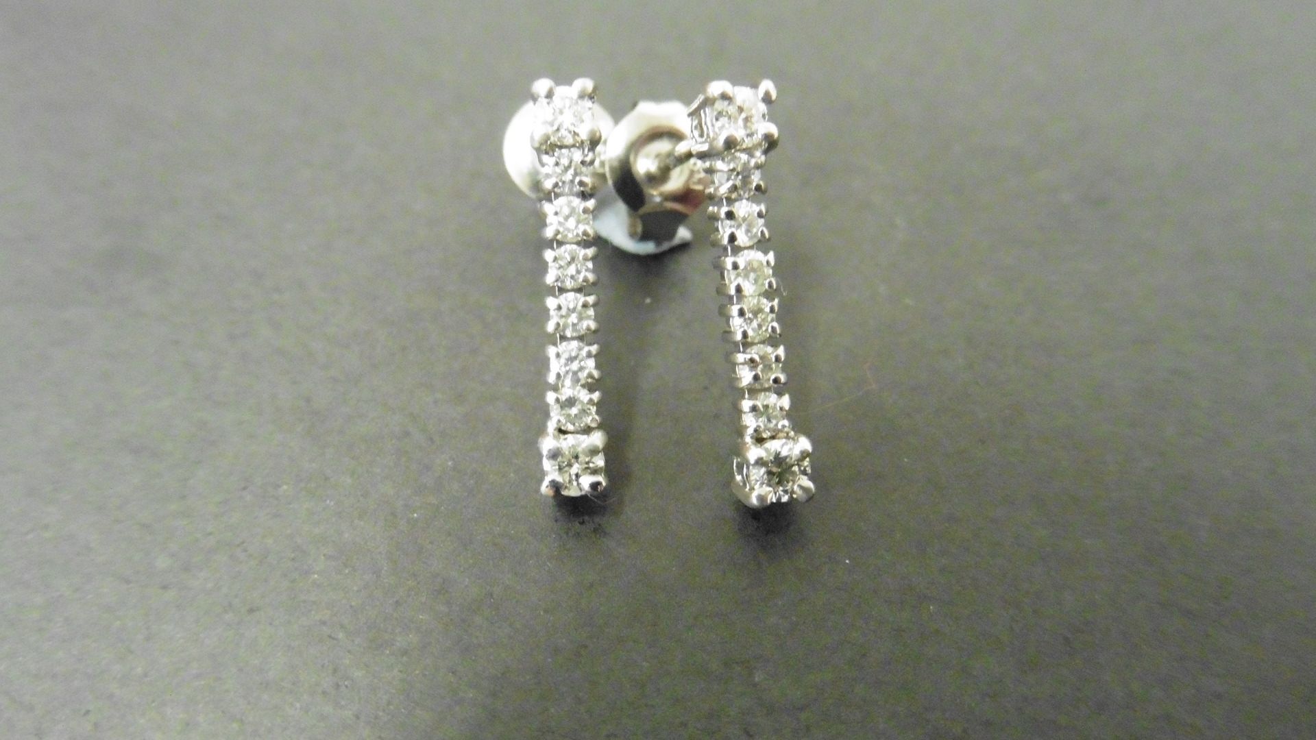 0.60ct diamond drop earrings set in 18ct white gold. Brilliant cut diamonds, I colour and Si3