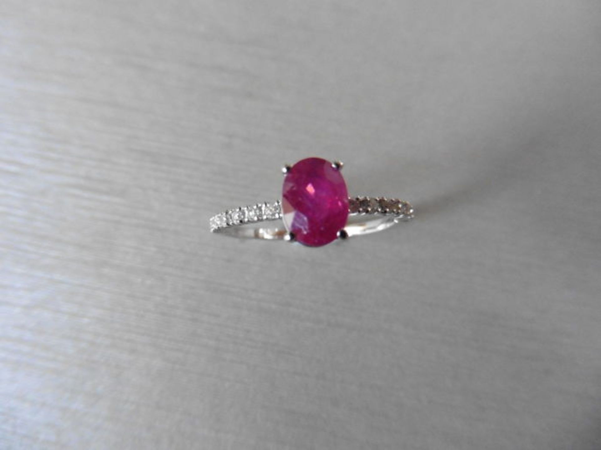 0.80ct / 0.12ct ruby and diamond dress ring. Oval cut ( glass filled) ruby with small diamonds set