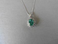 0.80ct emerald and diamond cluster style pendant. ÊOval cut treated emerald with 12 small