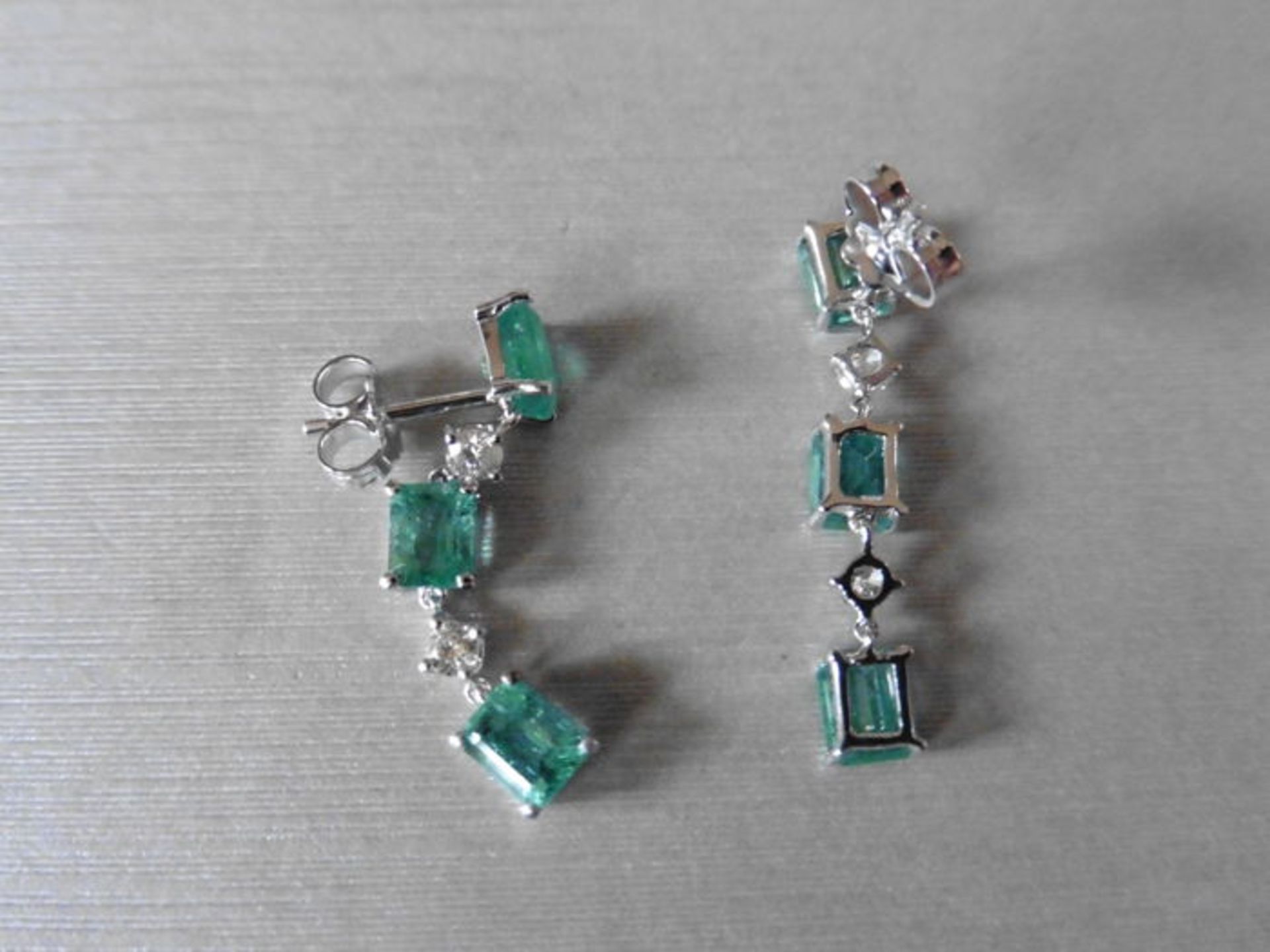 Emerald and diamond drop style earrings set in 18ct gold. Each set with 4 emerald cut ( treated) - Image 2 of 3