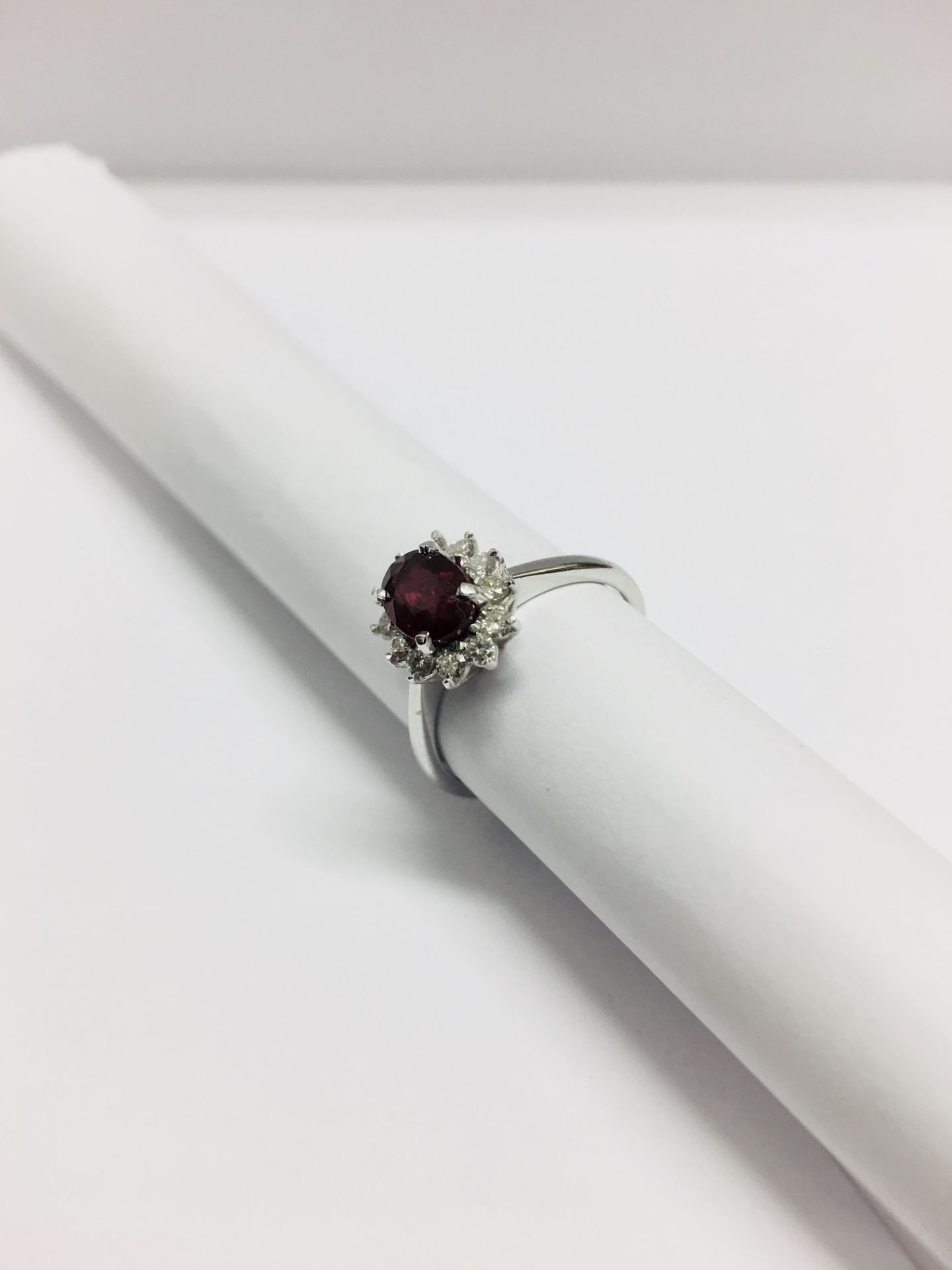0.80ct Ruby and diamond cluster ring set with a oval cut(glass filled) ruby which is surrounded by - Image 5 of 5