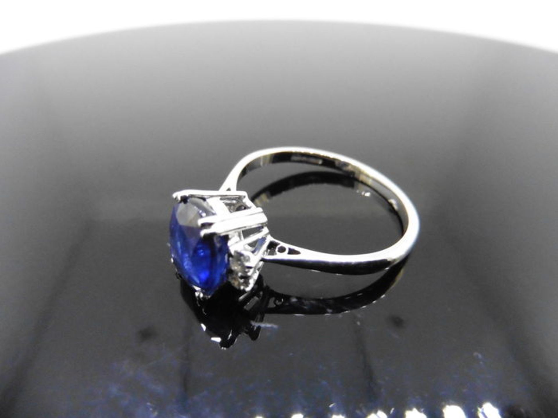 2.40ct sapphire and diamond ring. Oval cut ( glass filled ) sapphire with 2 small brilliant cut - Image 5 of 5