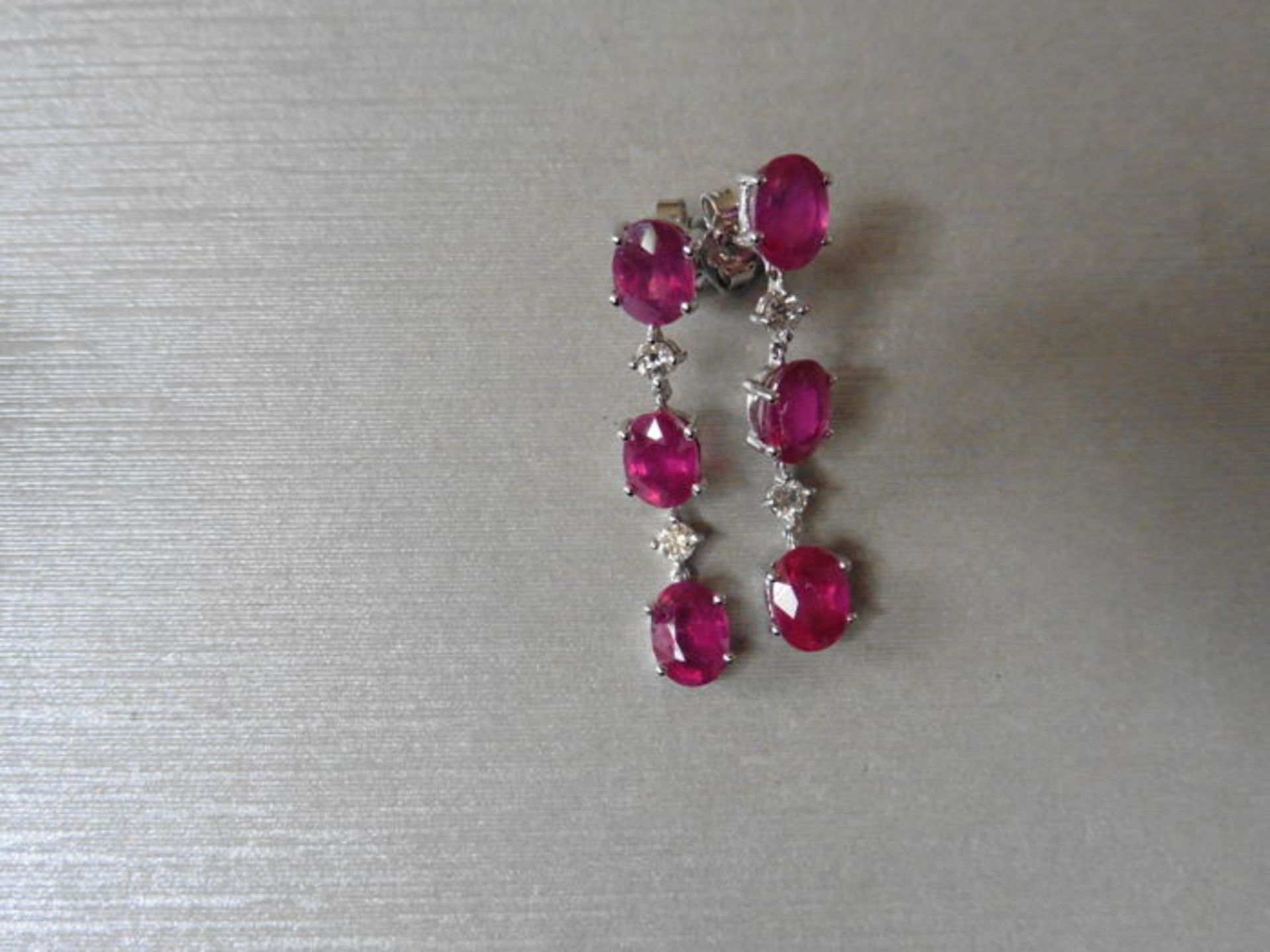 4.80ct ruby and diamond drop earrings set in 18ct gold. Each set with 3 oval cut rubies ( glass
