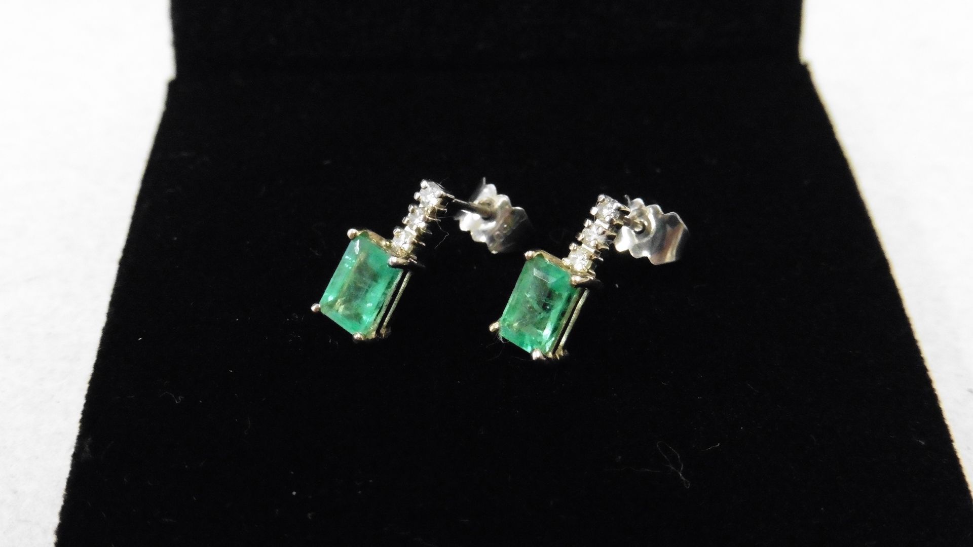 Emerald and diamond drop style earrings each set with an rectangular cut emerald, 6x4mm, weighing - Image 2 of 3