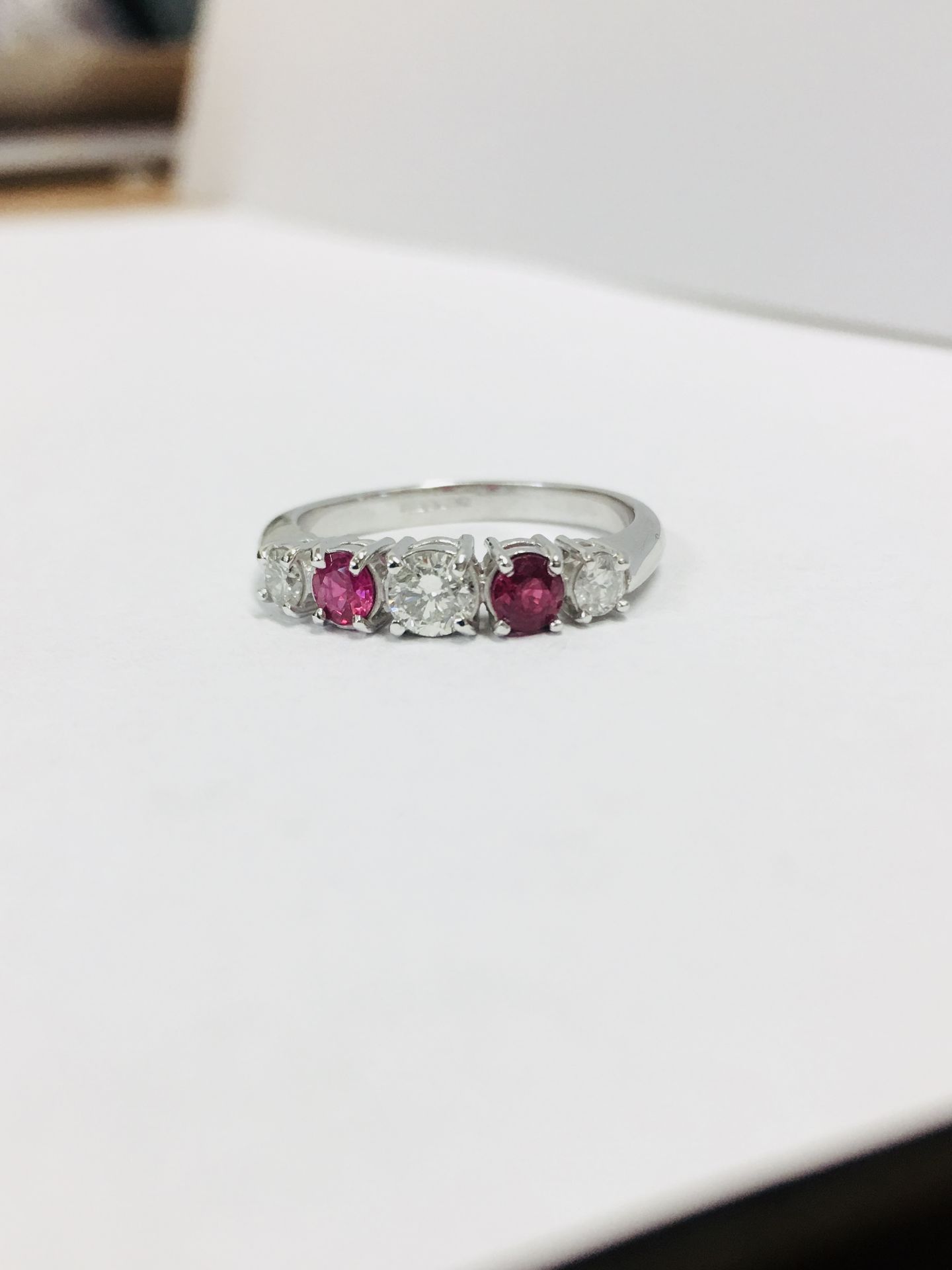 0.75ct ruby and diamond five stone ringset in 18ct gold. 2 rubies( treated ) 3 brilliant cut