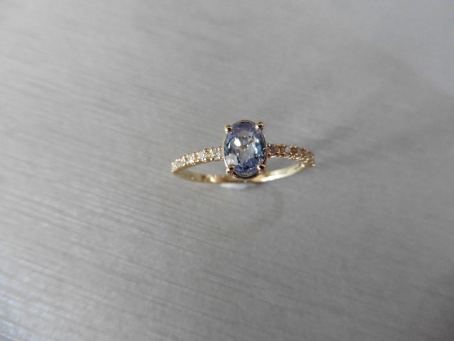 0.80ct / 0.12ct ceylon sapphire and diamond dress ring. Oval cut ( treated ) sapphire with small