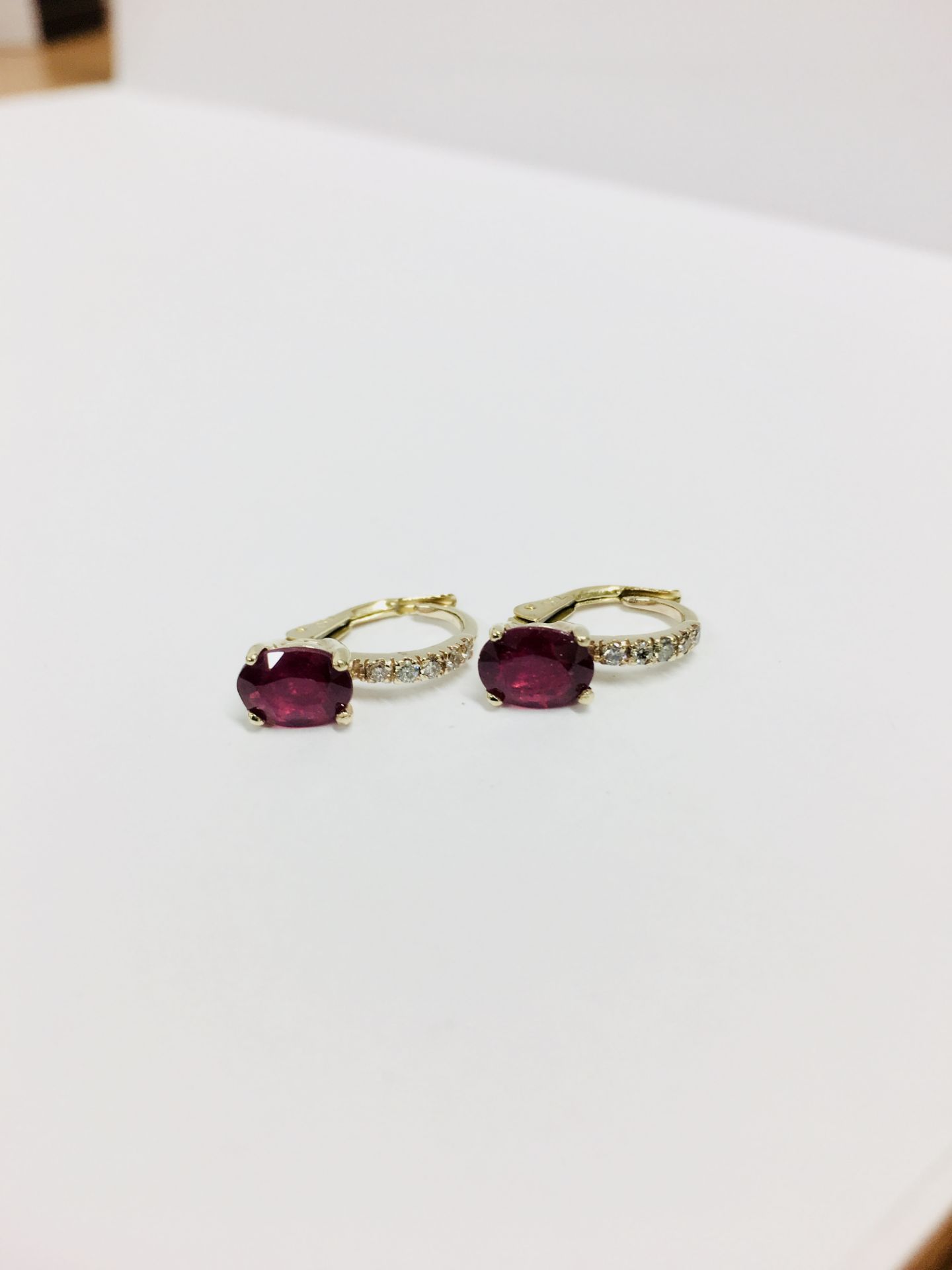 1.60ct Ruby and diamond hoop style earrings. Each is set with a 7x 5mm oval cut Ruby ( treated ) - Image 3 of 3