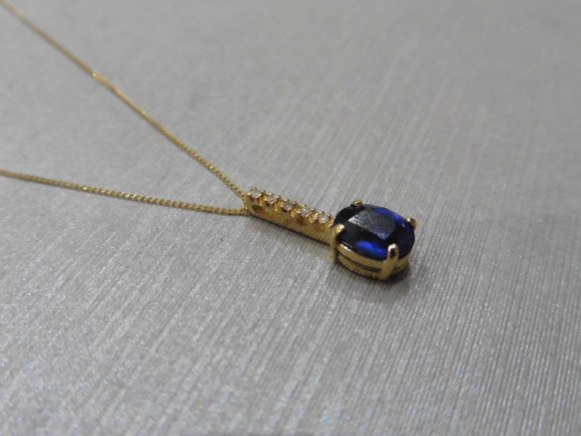 0.80ct sapphire and diamond drop style pendant. 7X 5mm oval sapphire set with 5 small brilliant - Image 2 of 3