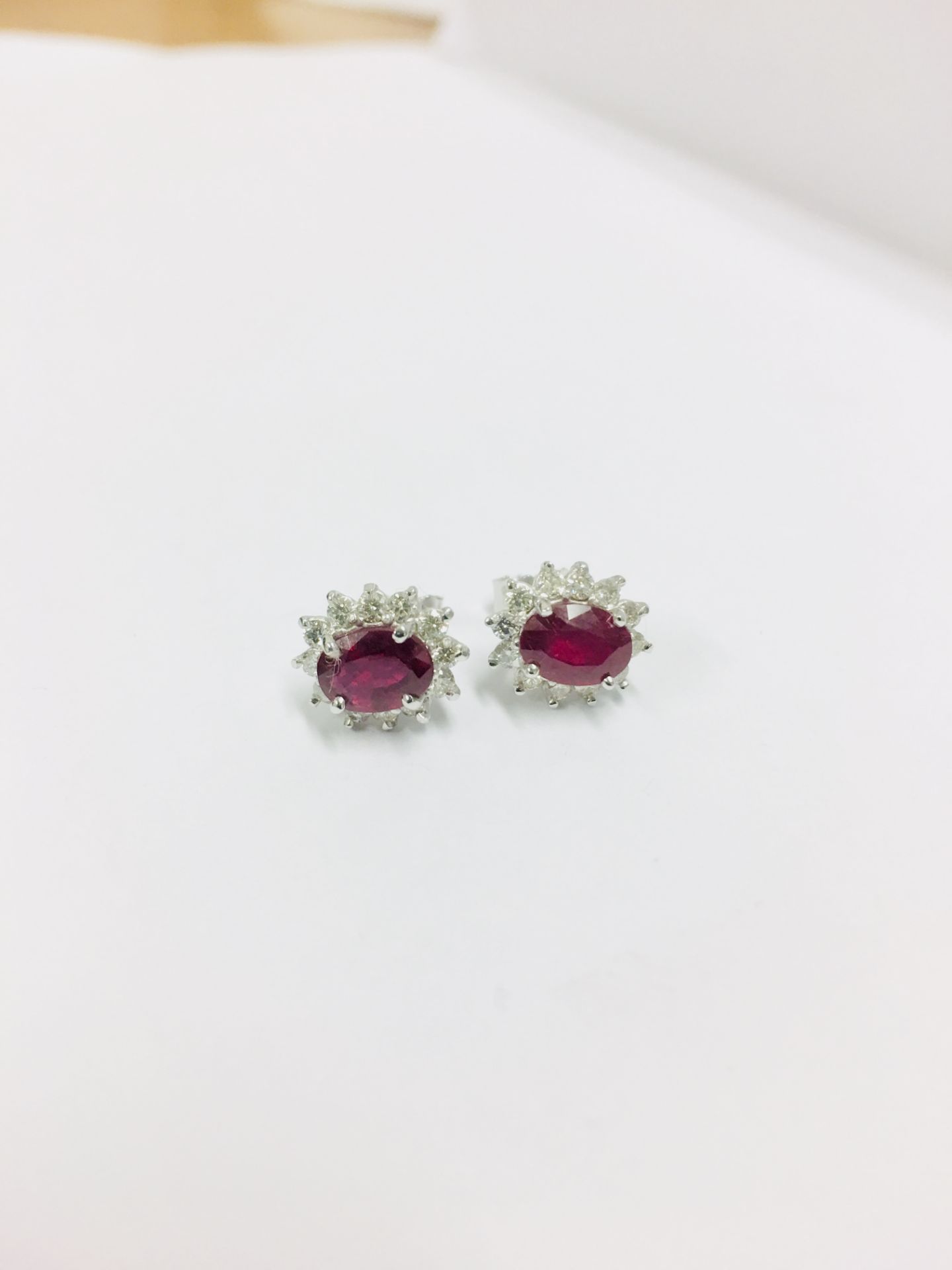 1.60ct ruby and Diamond cluster style stud earrings. Each ruby ( glass filled ) measures 7mm x 5mm