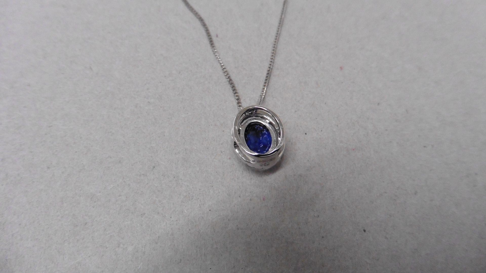 0.80ct halo set diamond pendant. Oval cut sapphire ( glass filled ) in the centre, 0.80ct, with a - Image 4 of 4