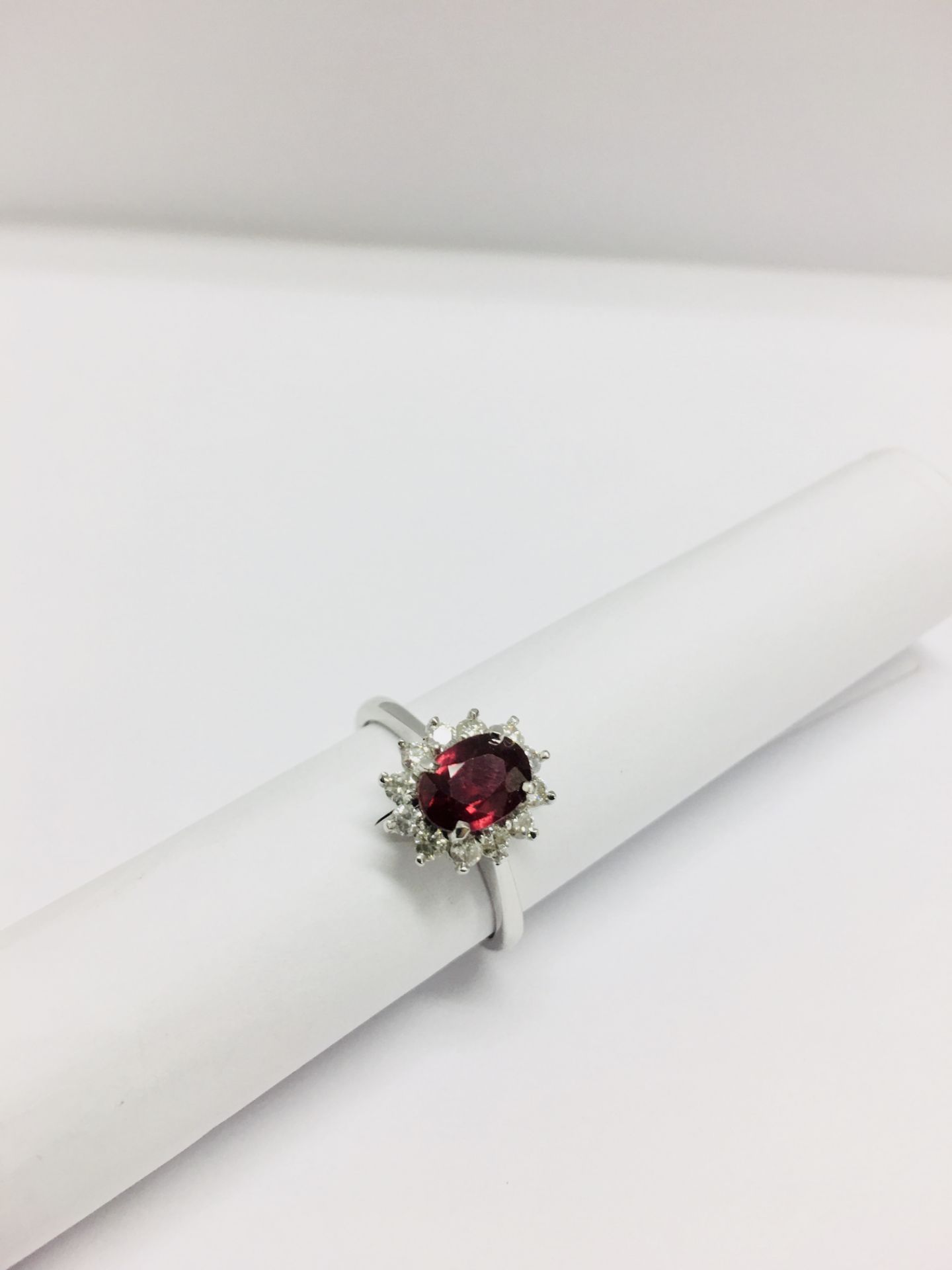 0.80ct Ruby and diamond cluster ring set with a oval cut(glass filled) ruby which is surrounded by - Image 3 of 5