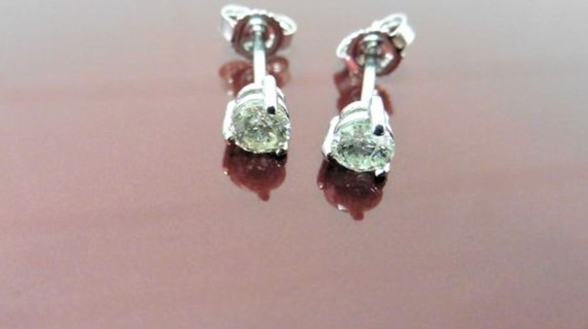 0.70ct diamond solitaire stud earrings set in platinum. I colour, si3 clarity. 3 claw setting with