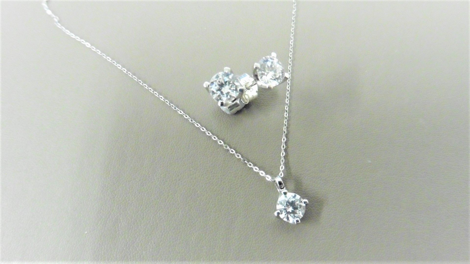 0.35ct / 0.70ct diamond pendant and earring set in platinum. Pendant - 0.35ct brilliant cut diamond,