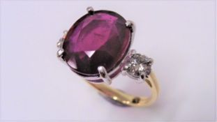 9ct ruby and diamond trilogy ring set in 18ct gold. Oval cut ruby ( fracture filled )weighing approx