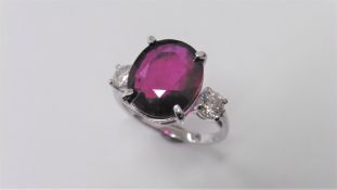 9ct ruby and diamond trilogy ring set in 18ct gold. Oval cut ruby ( fracture filled )weighing approx
