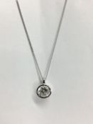 0.50ct diamond solitaire pendant set in a platinum rubover setting. H colour and VS clarity (
