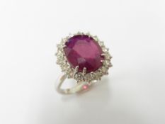 8.50ct ruby and diamond cluster dress ring set in platinum. Oval cut ruby ( fracture filled )