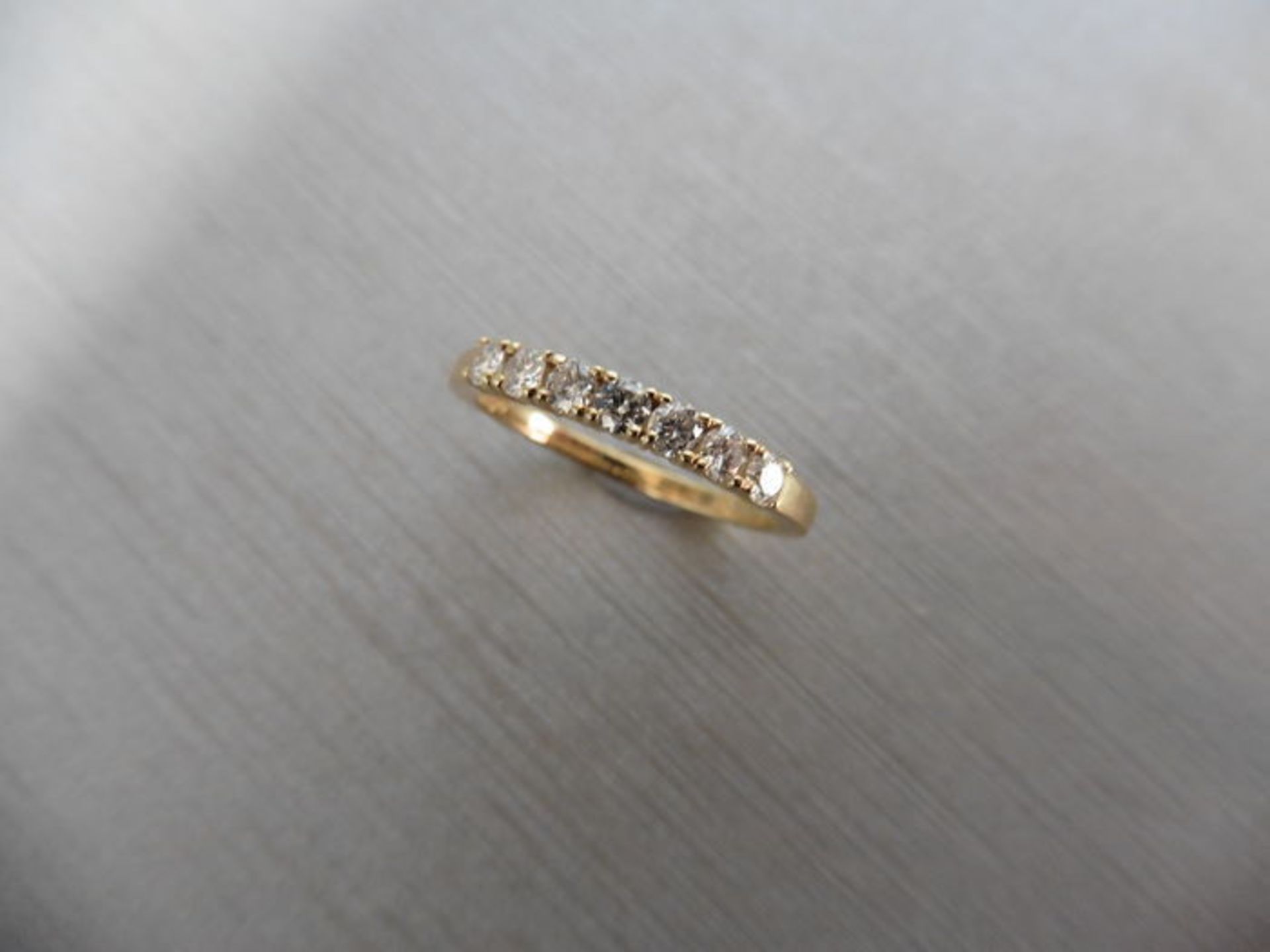 0.42ct diamond band ring set in 9ct yellow gold. 7 Small brilliant cut diamonds, I colour and i1 - Image 2 of 3