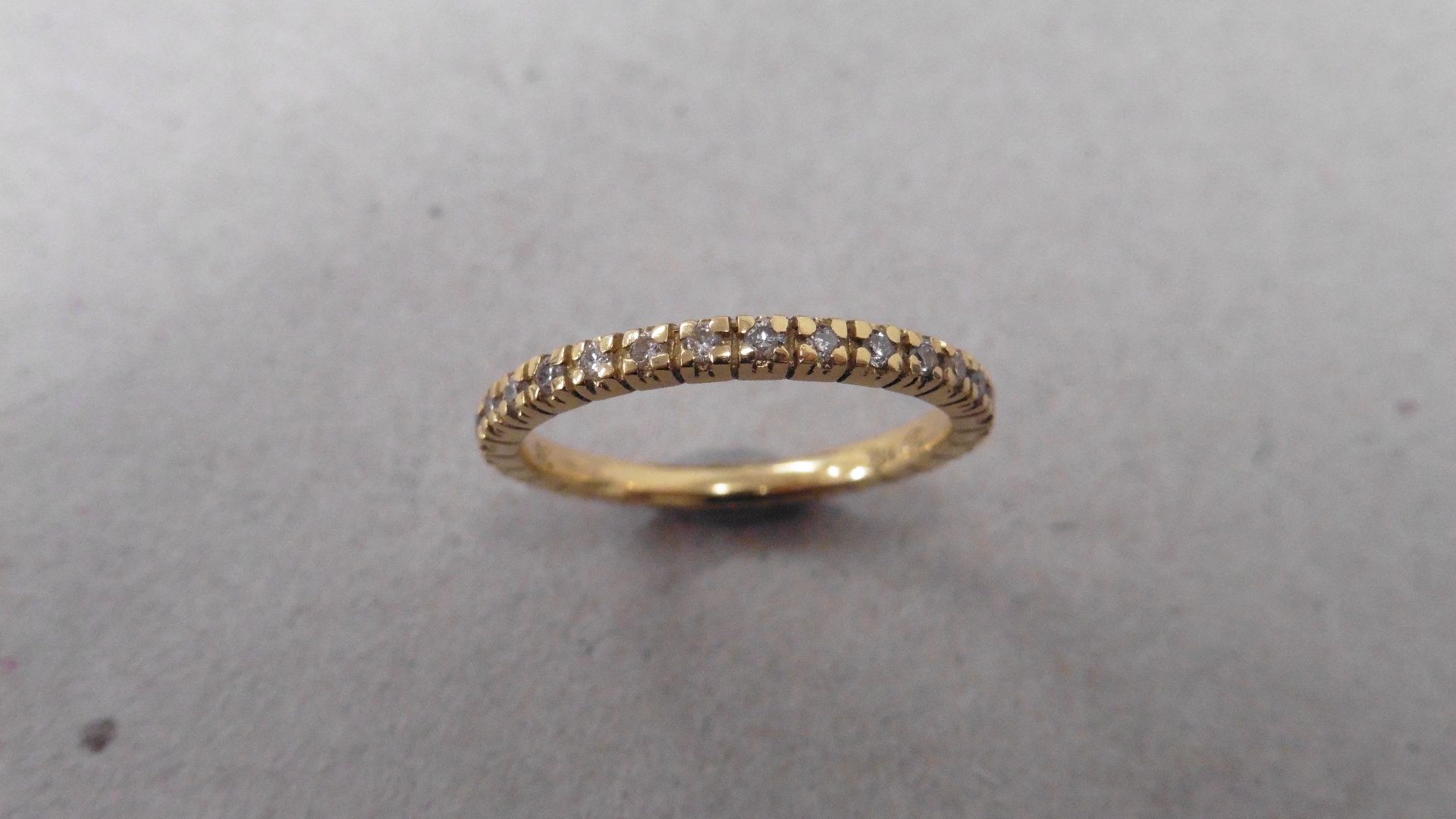 Diamond set band ring set in 18ct yellow gold. Brilliant cut diamonds set all the way round weighing