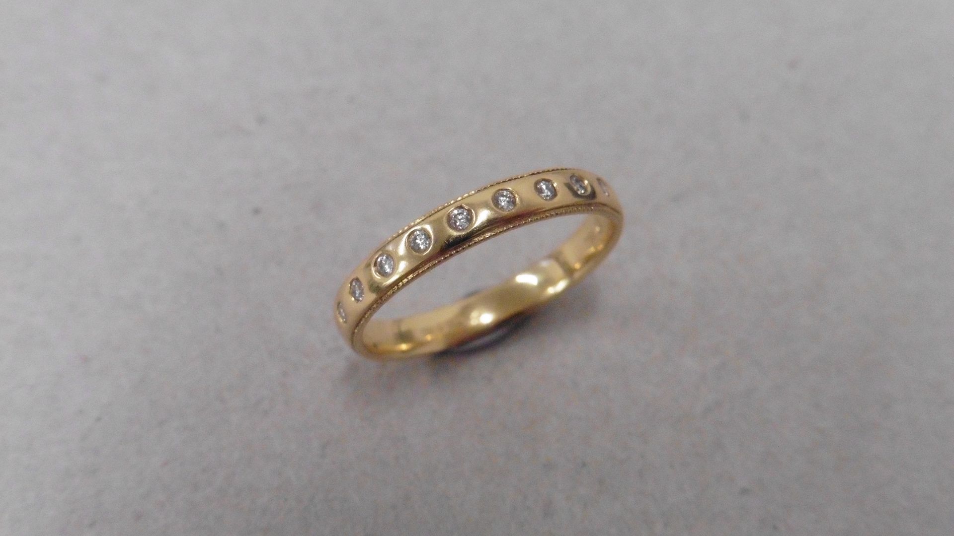 18ct yellow gold diamond set band ring. 9 small brilliant cut diamonds, H colour and si1-2