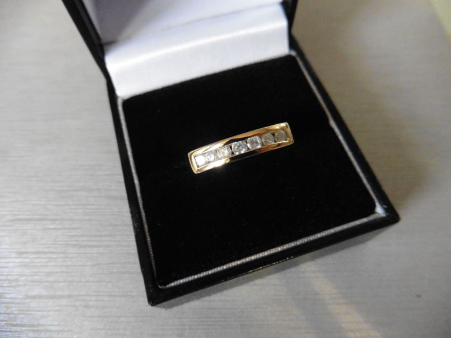 0.35ct diamond band ring set in 9ct yellow gold. Brilliant cut diamonds, I colour and si2 clarity.
