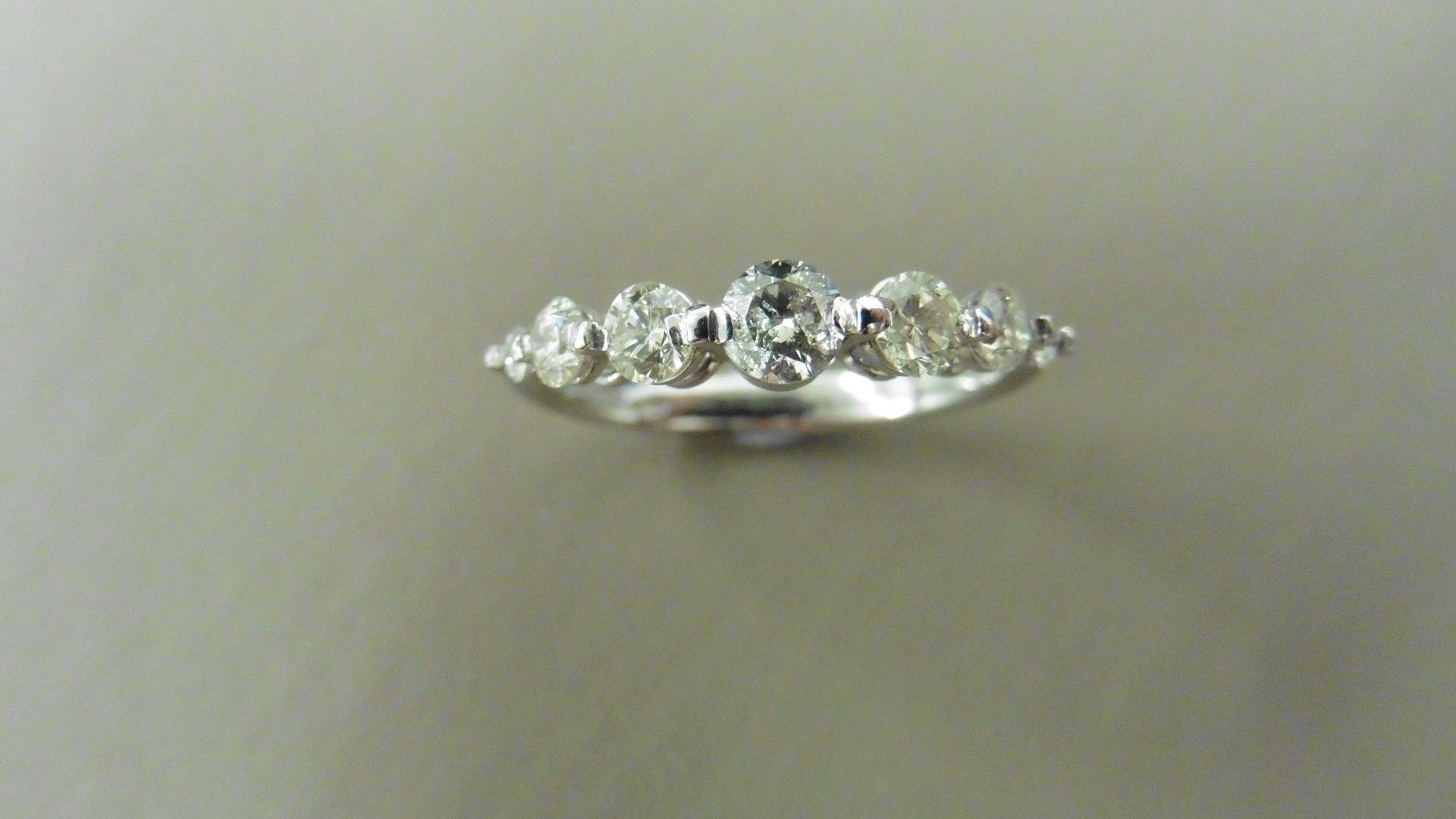 0.60ct diamond band ring set in 14ct white gold. 7 graduated brilliant cut diamonds, I colour and