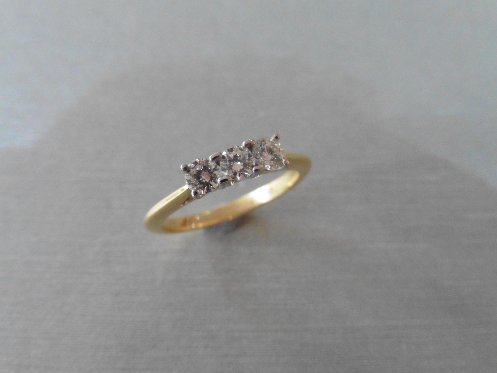 18ct gold diamond three stone ring set with three small brilliant cut diamonds, I colour and Si