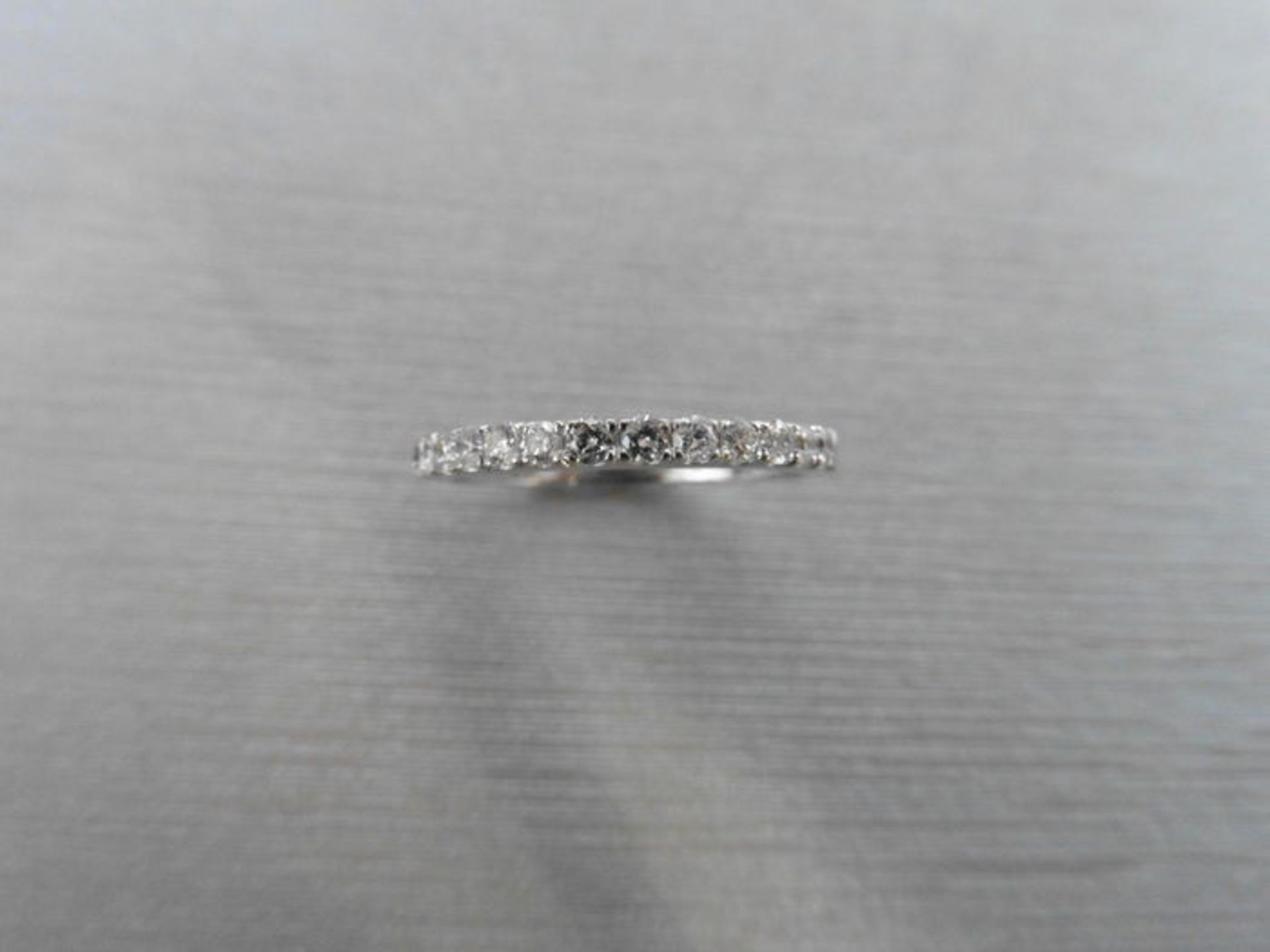 0.32ct diamond band ring set in 9ct white gold. Small brilliant cut diamonds, I colour and i1