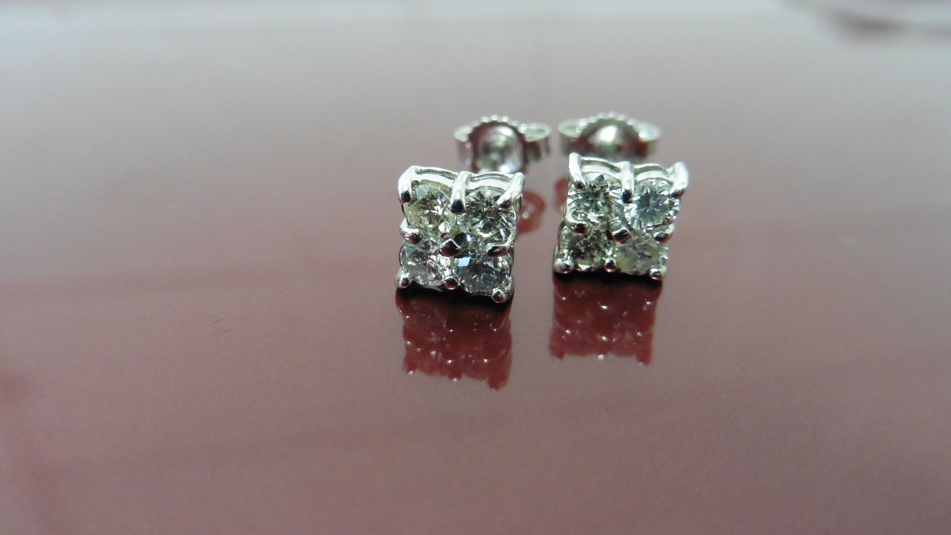 0.80ct dimond cluster style stud earrings. Each set with 4 small brillint cut diamonds, I colour and