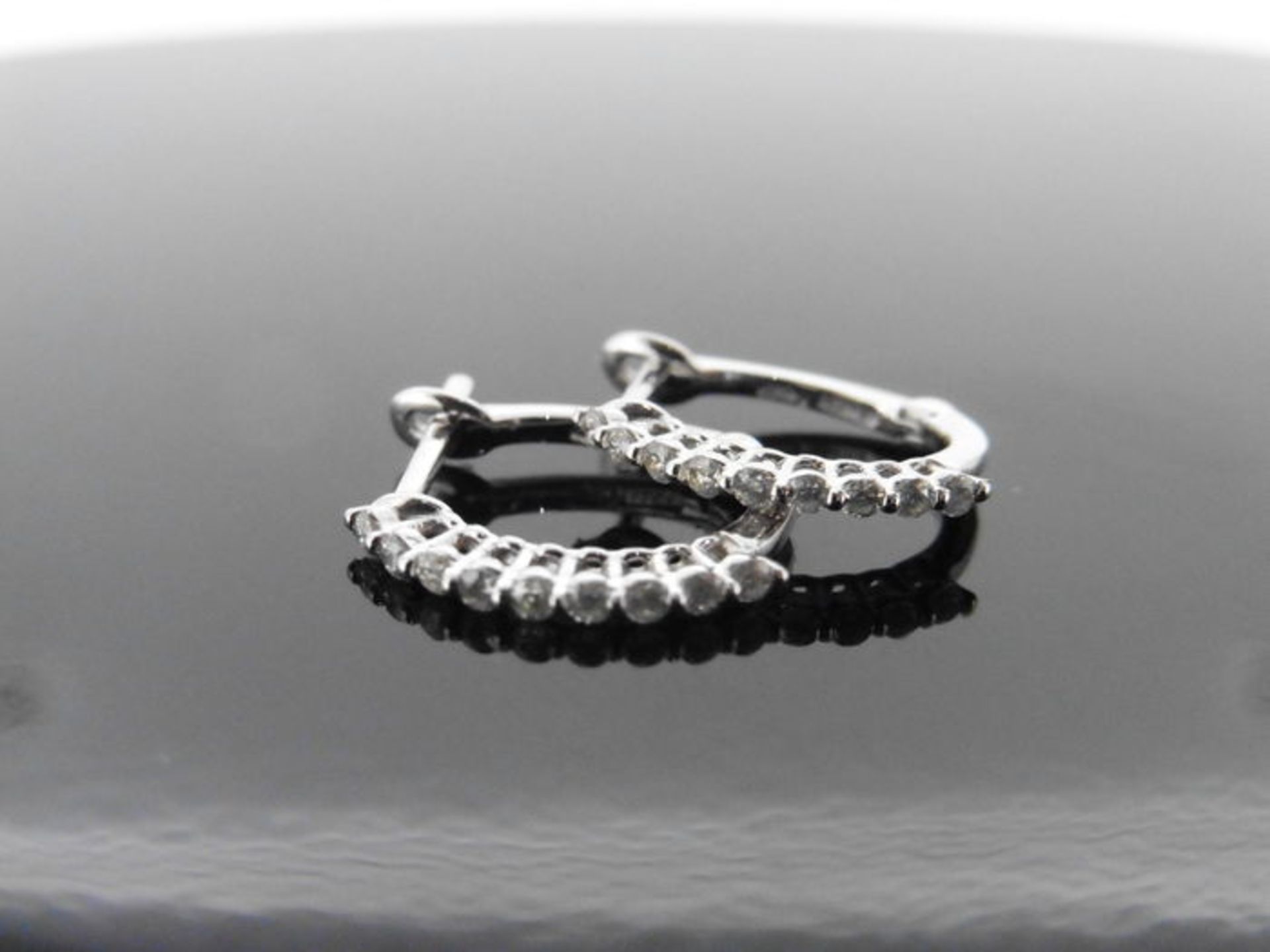 0.18ct diamond set hoop style earrings. Small brilliant cut diamonds, H/I colour, si2 clarity.