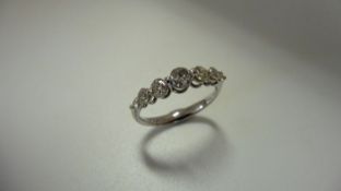 0.60ct diamond band ring set in 14ct white gold. 7 graduated brilliant cut diamonds, I colour and