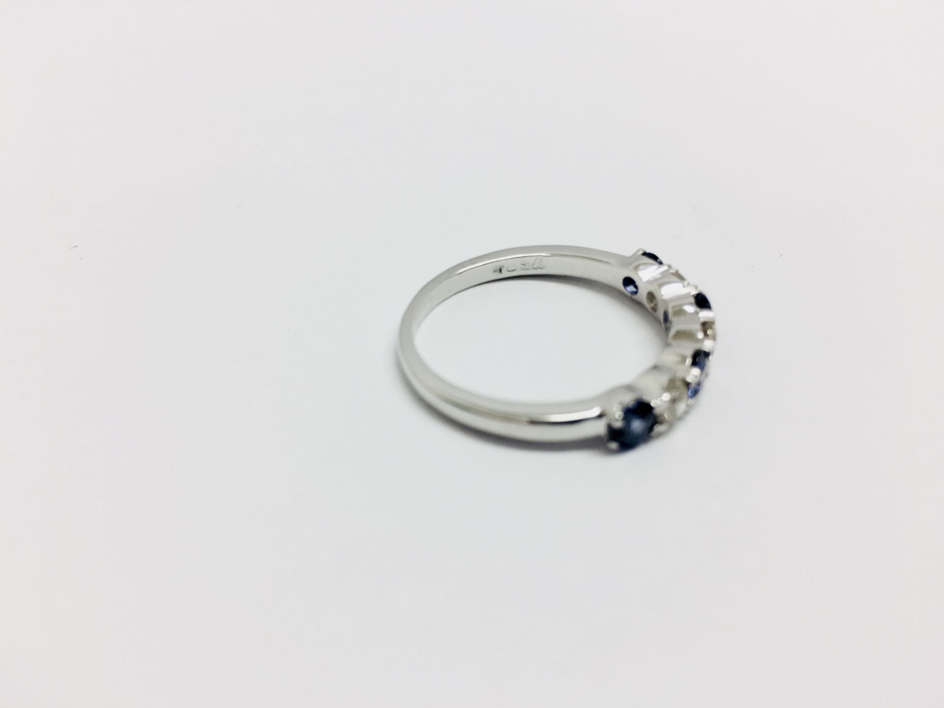 Sapphire and diamond eternity style ring. 4 round cut sapphires ( treated) 3 brilliant cut diamonds. - Image 3 of 4