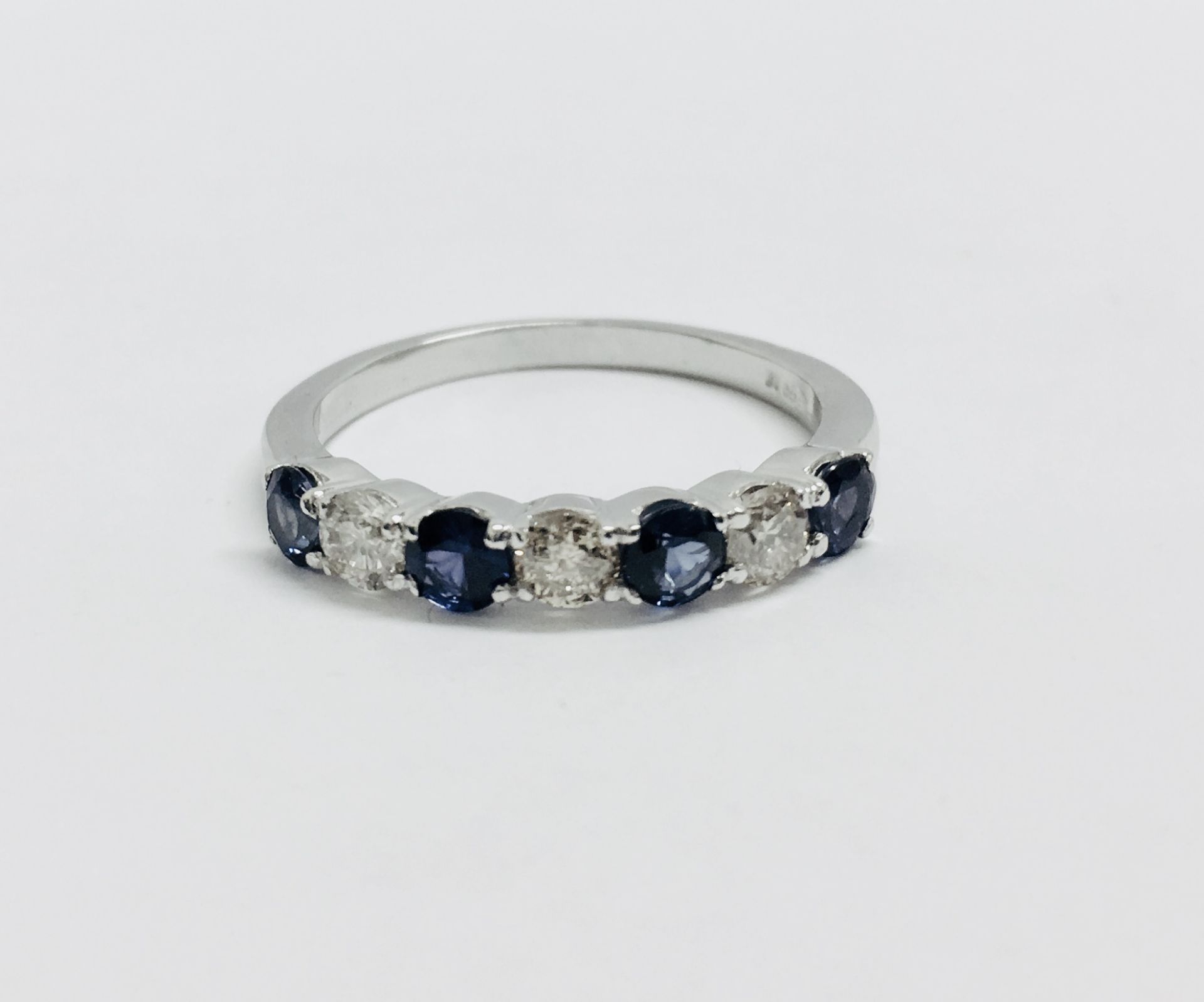 Sapphire and diamond eternity style ring. 4 round cut sapphires ( treated) 3 brilliant cut diamonds. - Image 4 of 4