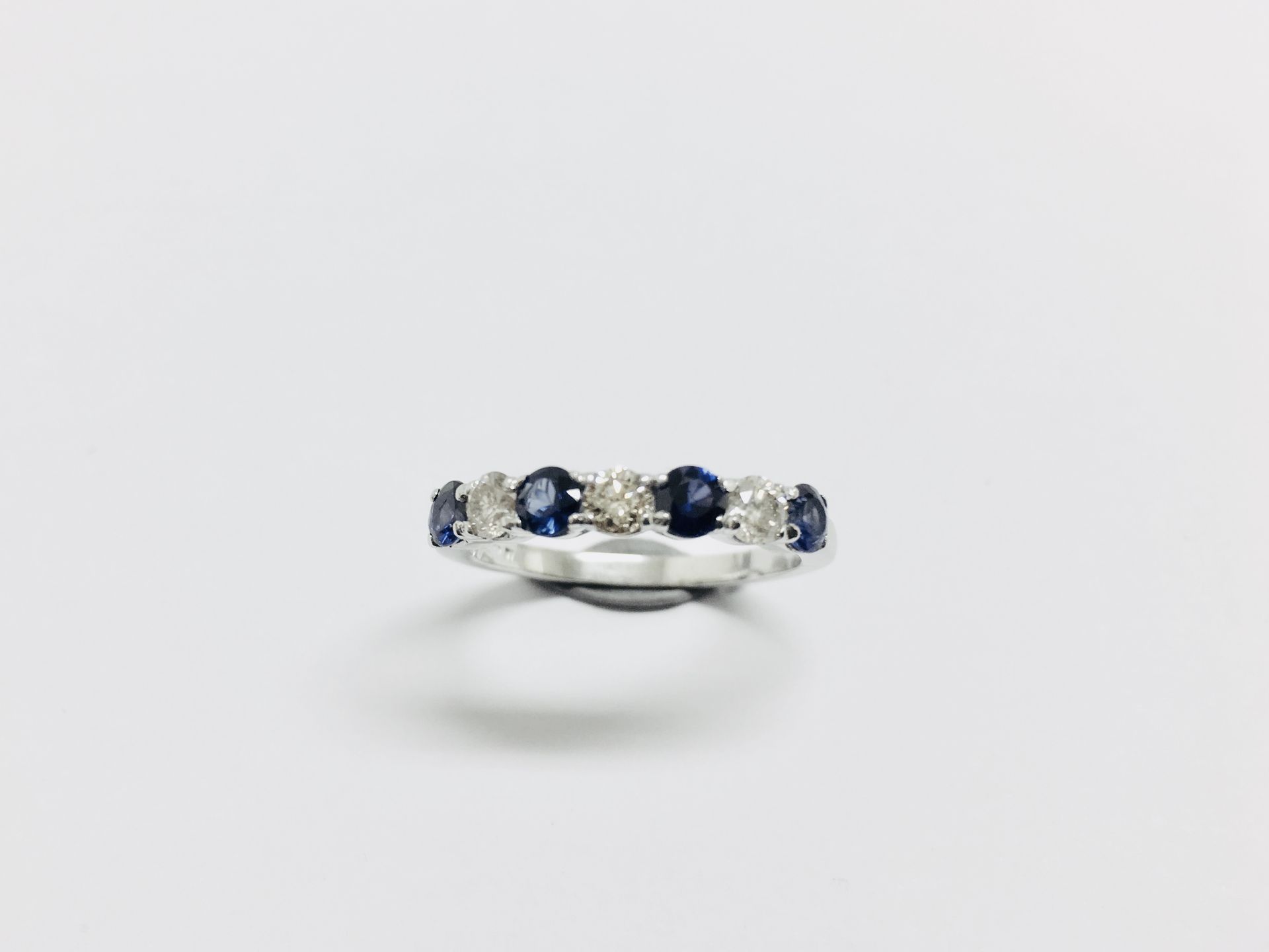 Sapphire and diamond eternity style ring. 4 round cut sapphires ( treated) 3 brilliant cut diamonds. - Image 2 of 4