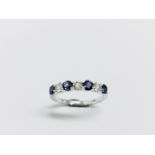 0.40ct sapphire and diamond eternity style ring. Set with 4 round cut sapphires and 3 diamonds. Size
