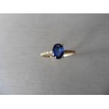 0.80ct / 0.12ct sapphire and diamond dress ring. Oval cut ( glass filled) sapphire with small