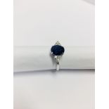 2.40ct Sapphire and diamond dress ring. Oval cut ( glass filled ) sapphire with 3 small brilliant