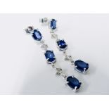 Sapphire and diamond drop style earrings set in 18ct gold. Each set with 3 oval cut ( treated)