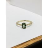 0.80ct / 0.12ct green sapphire and diamond dress ring. Oval cut ( treated ) sapphire with small