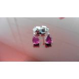 0.70ct drop style earrings. Each set with a pear shaped ruby ( glass filled ) and a small