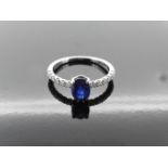 0.80ct / 0.12ct sapphire and diamond dress ring. Oval cut ( treated ) sapphire with small diamonds