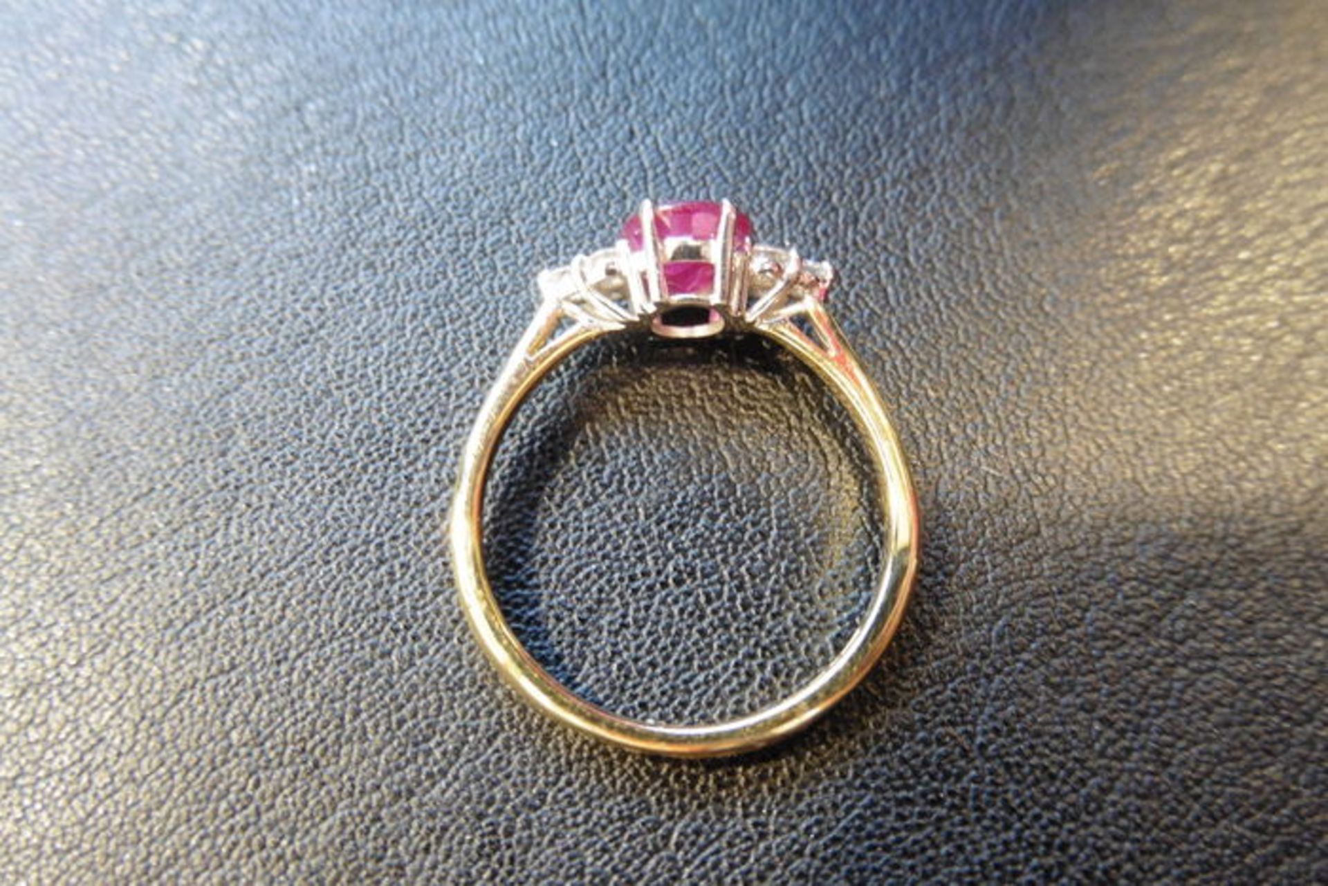 0.80ct ruby and diamond dress ring. 7x 5mm oval cutr uby (treated) with 3 small diamonds set - Image 2 of 3