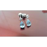 0.70ct drop style earrings. Each set with a pear shaped Aqua marine ( treated ) and a small