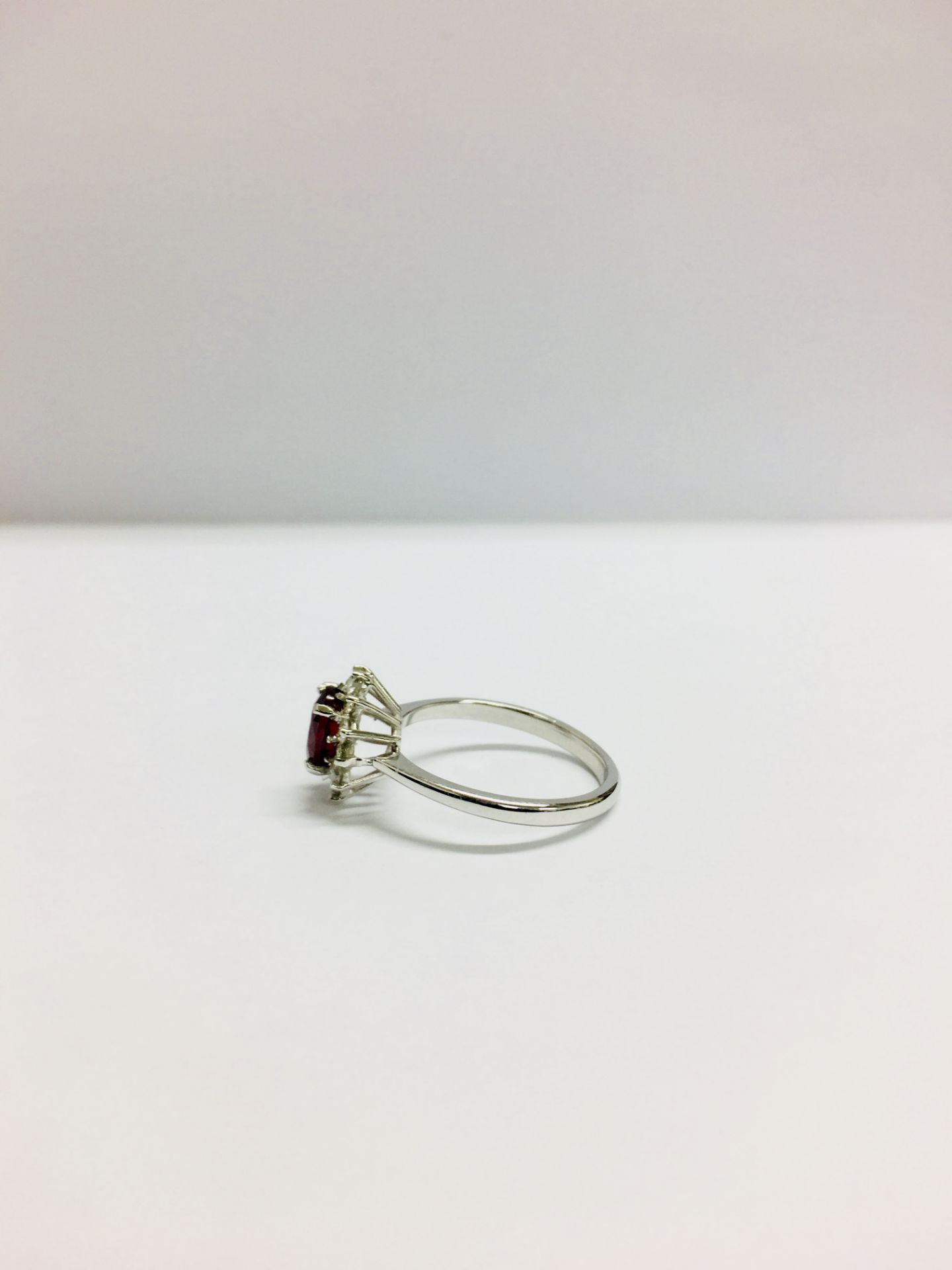 0.80ct Ruby and diamond cluster ring set with a oval cut(glass filled) ruby which is surrounded by - Image 2 of 5