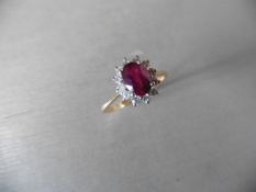 0.75ct / 0.30ct ruby and diamond cluster ring. Oval cut ( glass filled )ruby surrounded by small