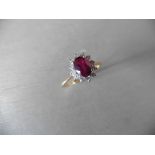 0.75ct / 0.30ct ruby and diamond cluster ring. Oval cut ( glass filled )ruby surrounded by small