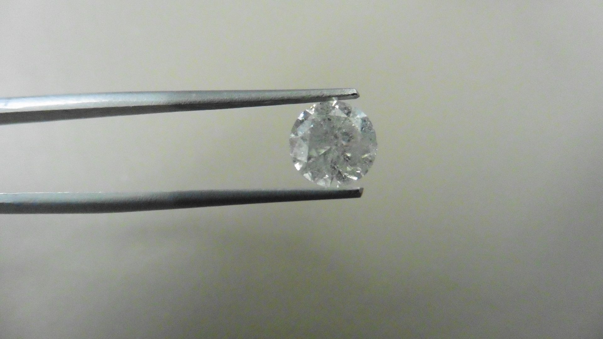 1.72ct Brilliant Cut Diamond, Enhanced stone. H/I colour, P1-2 clarity. 7.42 x 4.78mm. Valued at £