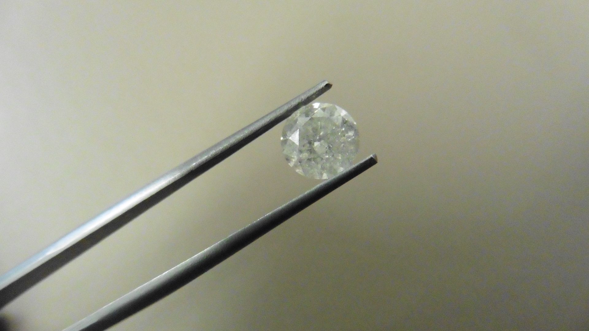 1.55ct Brilliant Cut Diamond, Enhanced stone. H colour, P1-2 clarity. 7.07 x 4.73mm. Valued at £